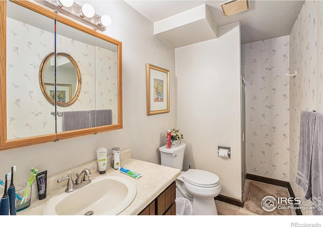 bathroom featuring tile flooring, large vanity, and toilet