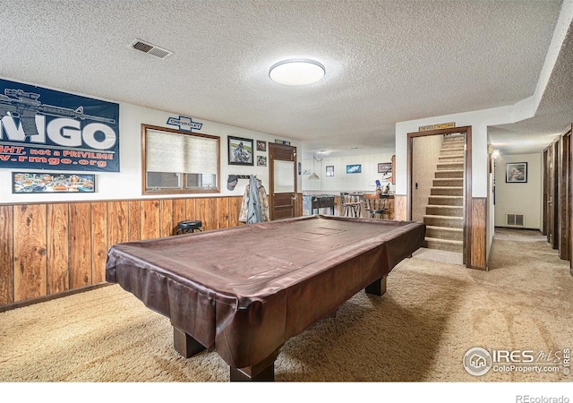 game room featuring light carpet, a textured ceiling, and pool table