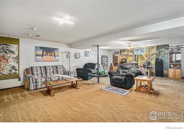 living room with a textured ceiling, light colored carpet, and ceiling fan