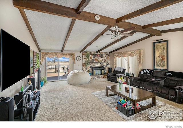 carpeted living room featuring vaulted ceiling with beams, a textured ceiling, and a fireplace