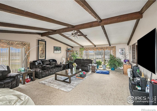 living room with ceiling fan, lofted ceiling with beams, carpet, and a textured ceiling