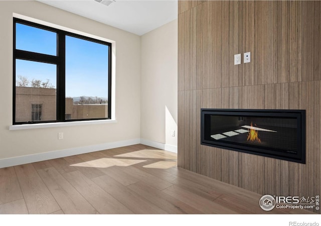 interior space with a fireplace and hardwood / wood-style floors