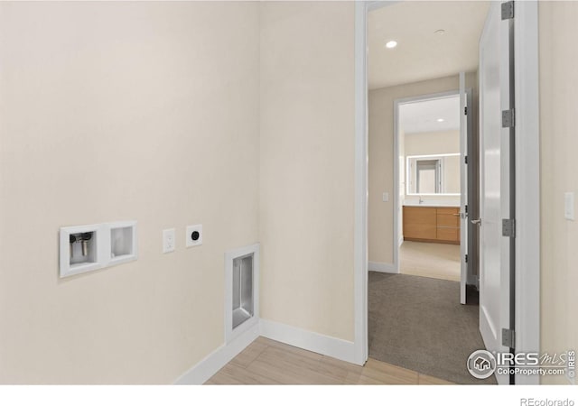 laundry room featuring electric dryer hookup, hookup for a washing machine, and light colored carpet