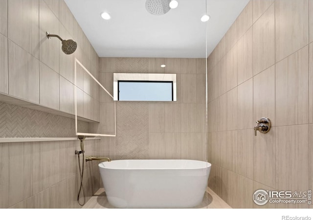 bathroom featuring separate shower and tub and tile walls