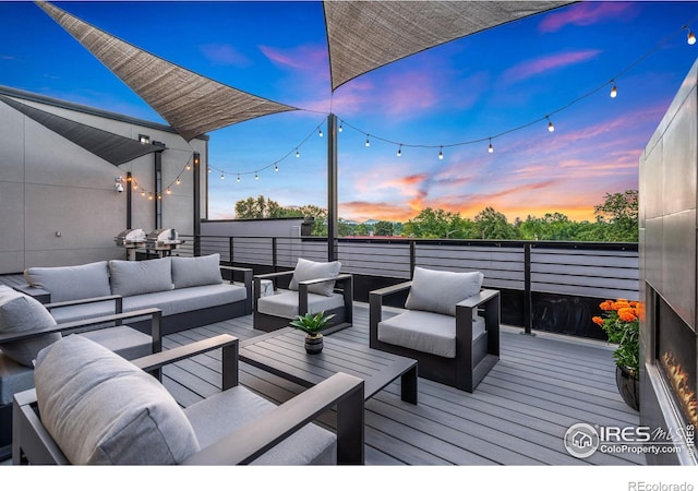 deck at dusk with an outdoor living space