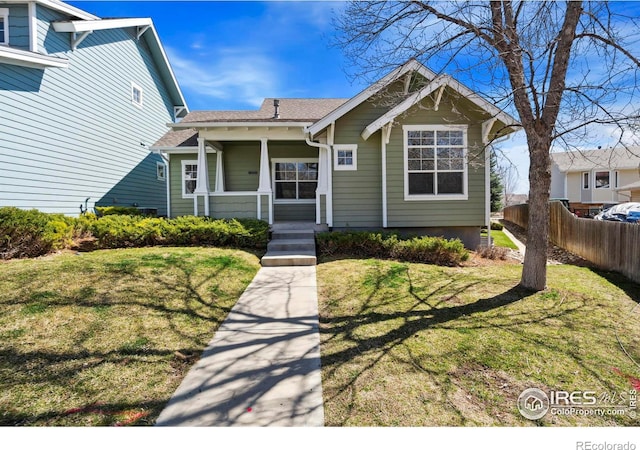 bungalow featuring a front yard