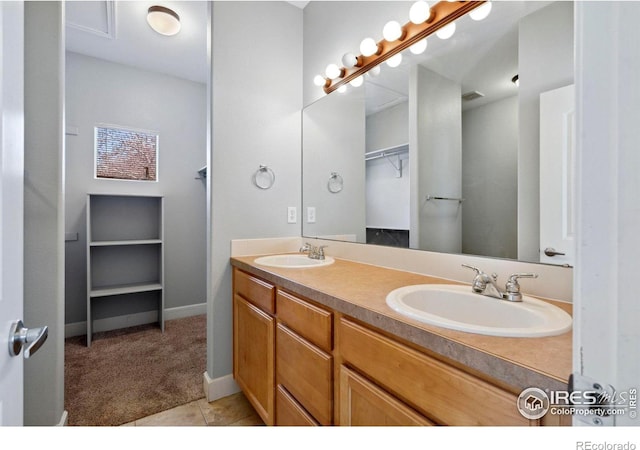 bathroom with double sink vanity and tile flooring