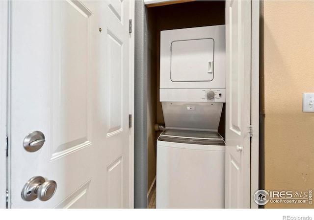 washroom featuring stacked washing maching and dryer