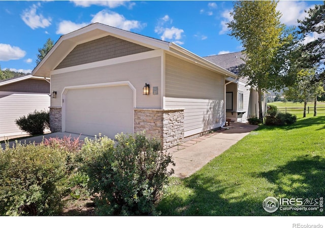 exterior space featuring a garage and a lawn