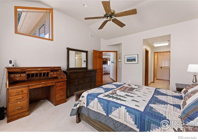 bedroom featuring light carpet, high vaulted ceiling, ceiling fan, and ensuite bathroom