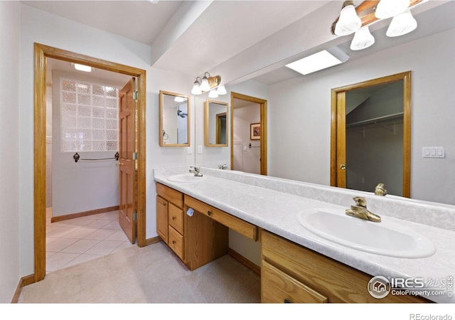 bathroom featuring dual sinks, oversized vanity, and tile floors