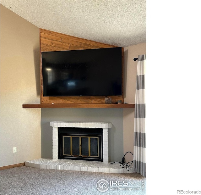 interior details featuring a textured ceiling, carpet, and a brick fireplace