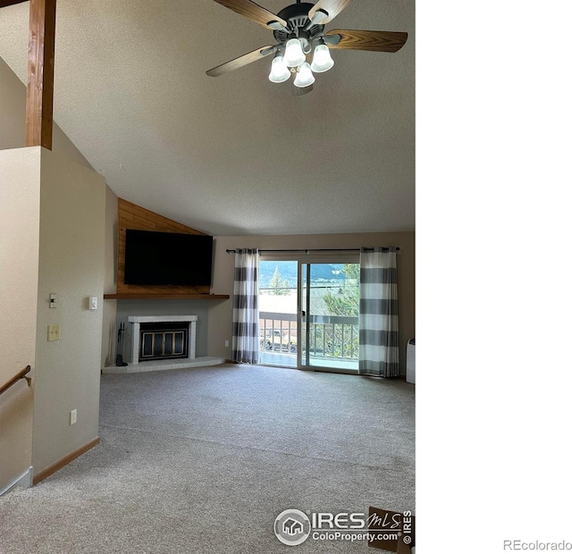 unfurnished living room featuring ceiling fan, vaulted ceiling, a textured ceiling, and carpet flooring