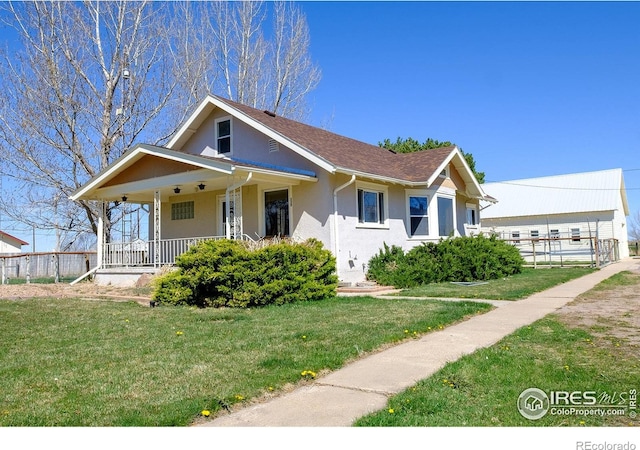 view of front of home with a front yard and a porch