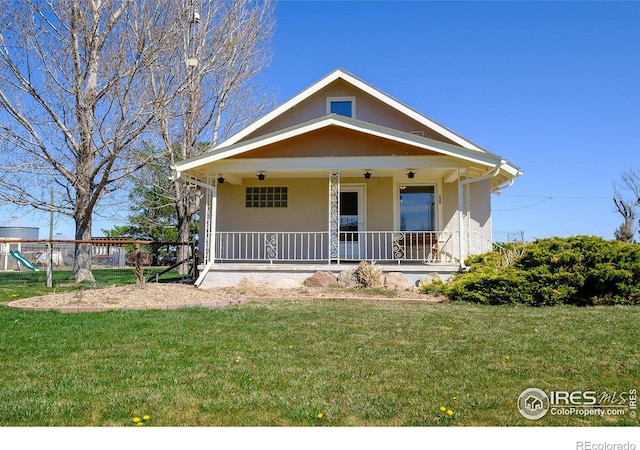 view of front of property with a playground, a front lawn, and covered porch