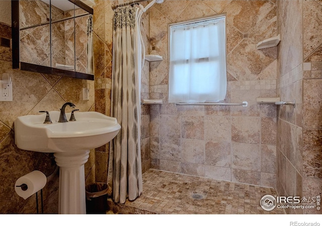 bathroom with tile walls, a shower with curtain, and backsplash