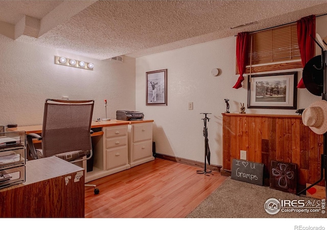 office area featuring a textured ceiling and light hardwood / wood-style floors