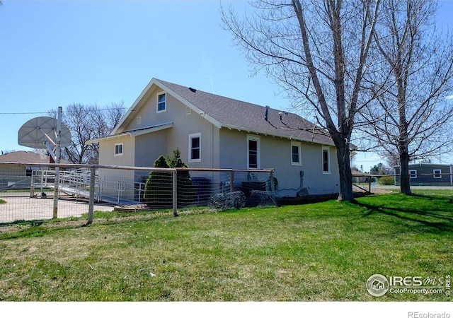 rear view of property with a yard