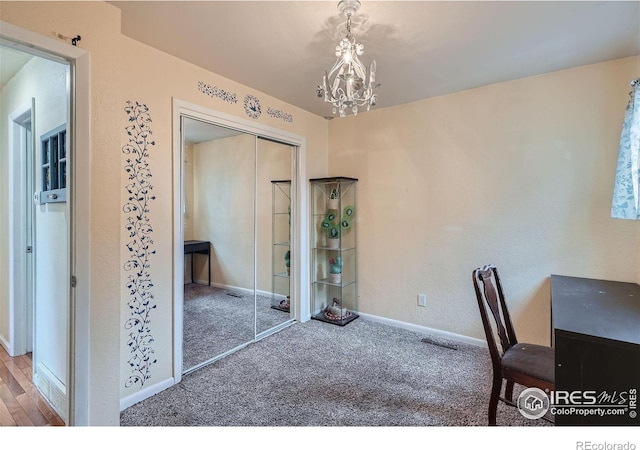 office area with hardwood / wood-style floors and a notable chandelier