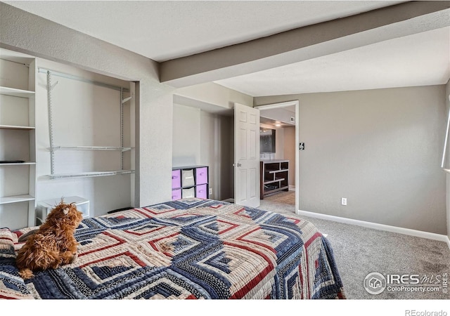 bedroom featuring carpet and lofted ceiling