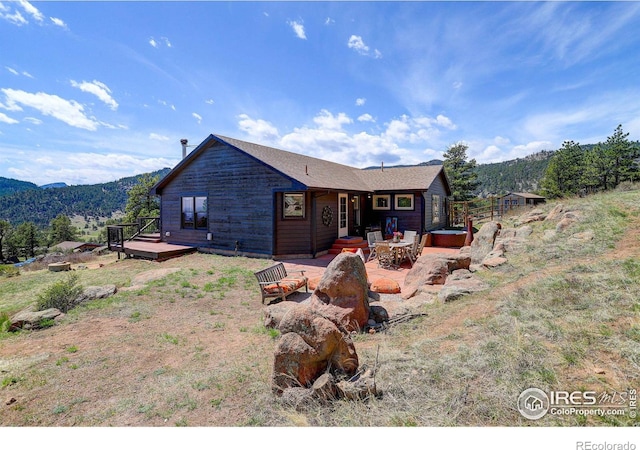 1553 Rowell Dr, Lyons, CO 80540 - back of property featuring a patio and a deck with mountain view