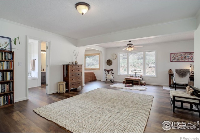 1553 Rowell Dr, Lyons, CO 80540 - bedroom featuring ornamental molding, dark wood-style flooring, arched walkways, and baseboards