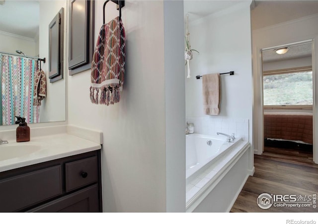 1553 Rowell Dr, Lyons, CO 80540 - full bath with crown molding, vanity, wood finished floors, and a garden tub