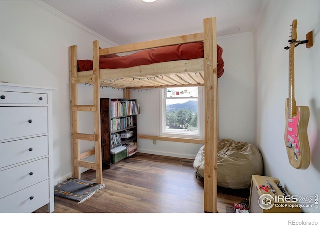 1553 Rowell Dr, Lyons, CO 80540 - bedroom with crown molding, wood finished floors, and baseboards
