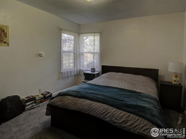 bedroom featuring carpet floors and a textured ceiling