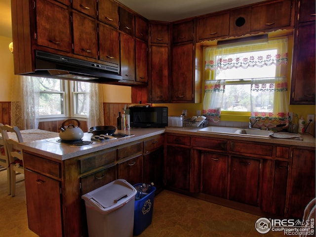 kitchen featuring light tile patterned flooring, electric stovetop, and sink