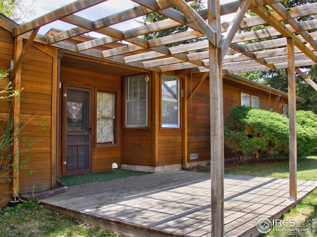 wooden deck with a patio and a pergola