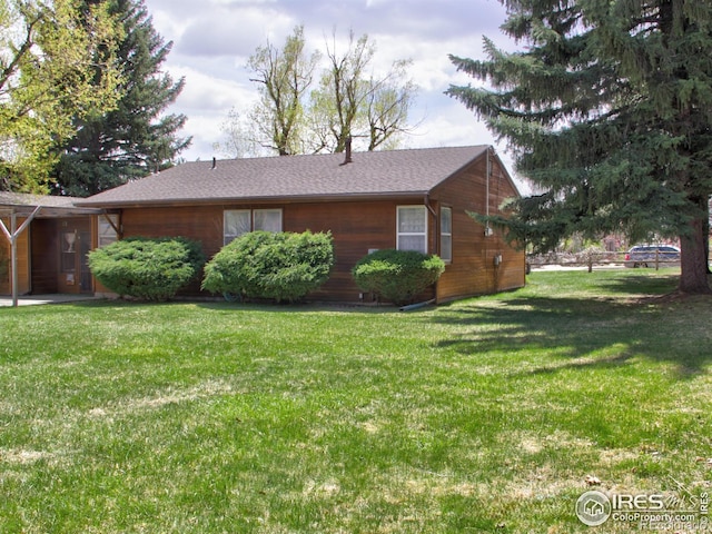 view of side of property with a yard