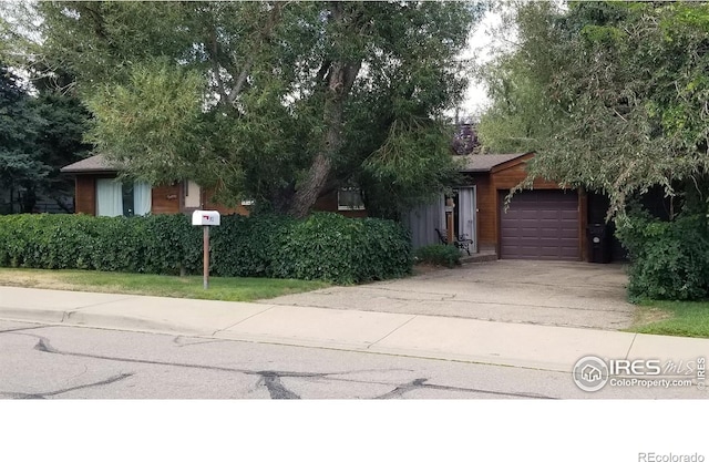 obstructed view of property featuring a garage