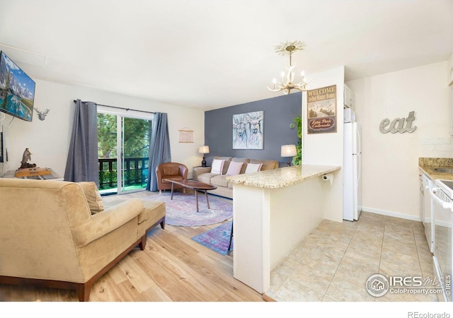 living room with light hardwood / wood-style flooring and a chandelier