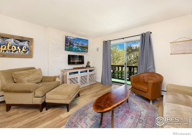 living room with brick wall and wood-type flooring