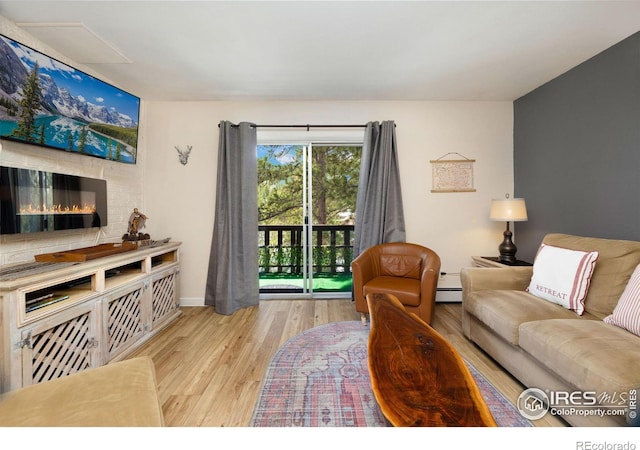 living room featuring light hardwood / wood-style floors and a baseboard radiator