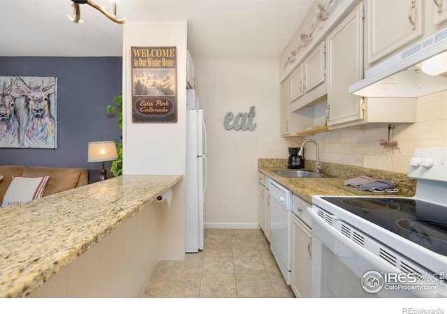 kitchen with white cabinets, white appliances, light tile floors, sink, and tasteful backsplash