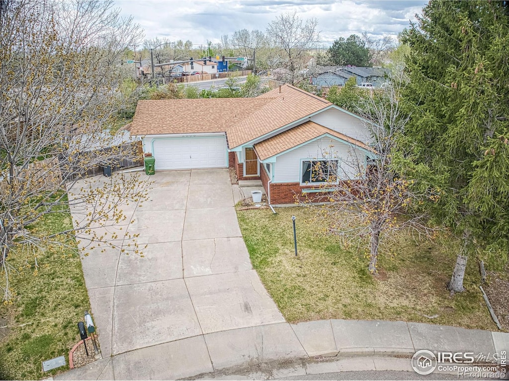 view of front of property with a garage and a front lawn