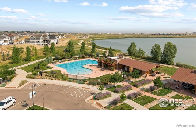 view of swimming pool featuring a water view