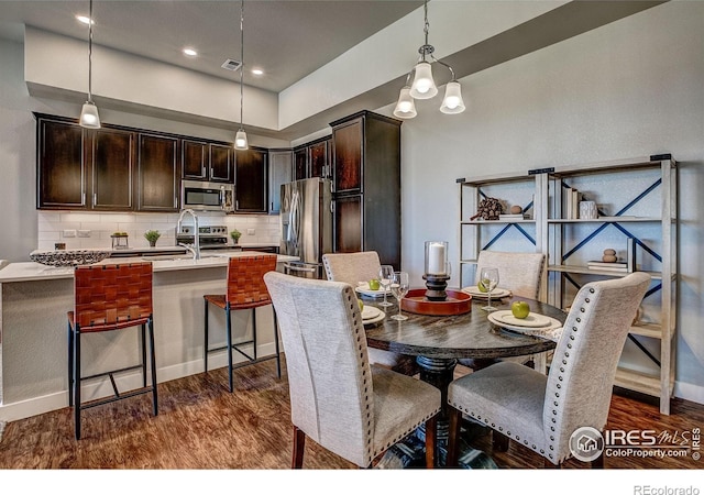 dining room with dark hardwood / wood-style floors