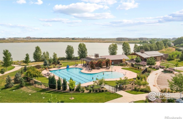 view of pool with a gazebo, a water view, a patio area, and a yard