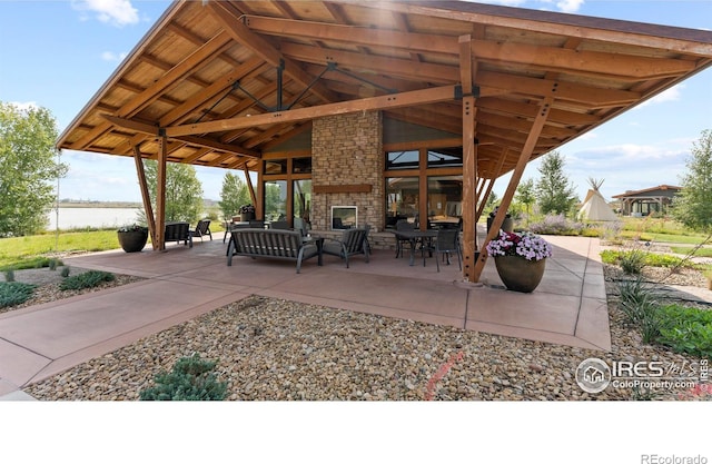 view of patio with a water view and outdoor lounge area