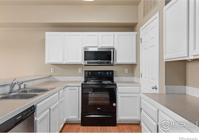 6925 19th St Unit 15, Greeley, CO 80634 - kitchen with sink, appliances with stainless steel finishes, light hardwood / wood-style floors, and white cabinetry