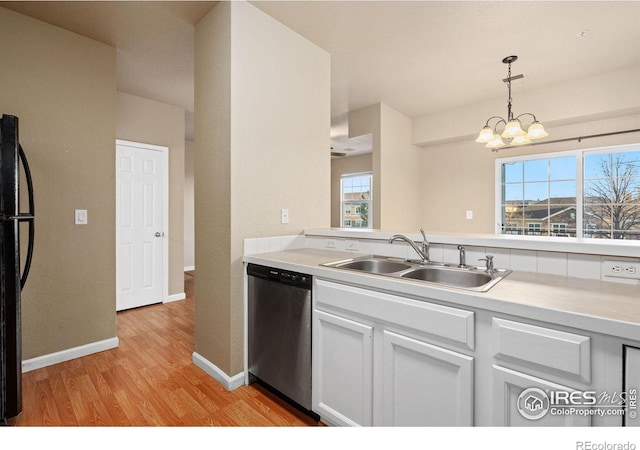 6925 19th St Unit 15, Greeley, CO 80634 - kitchen featuring a wealth of natural light, light hardwood / wood-style flooring, dishwasher, and black fridge
