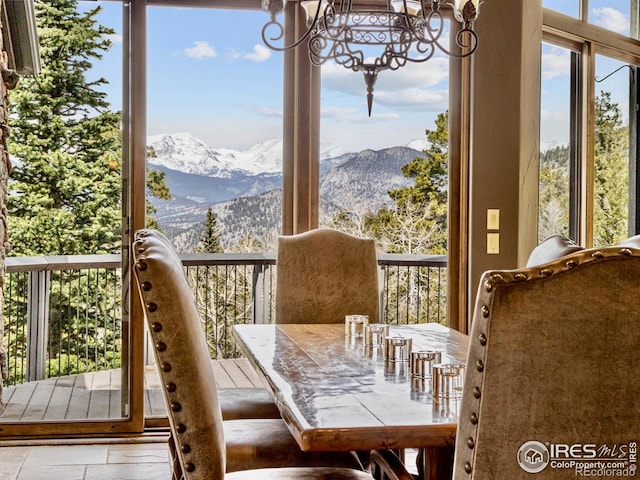 dining area featuring a chandelier and a mountain view