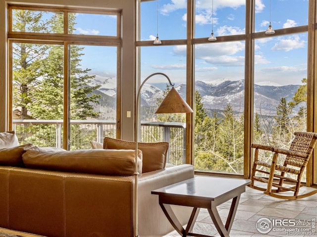 sunroom / solarium featuring a mountain view and a healthy amount of sunlight