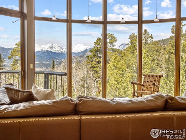 living room with floor to ceiling windows and a mountain view