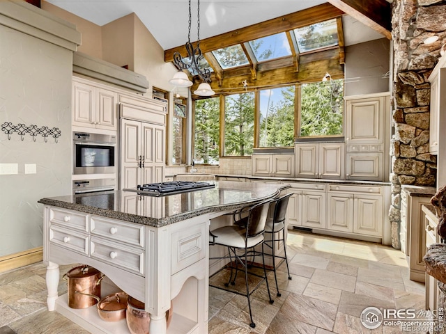 kitchen featuring cream cabinets, stainless steel appliances, and a kitchen island