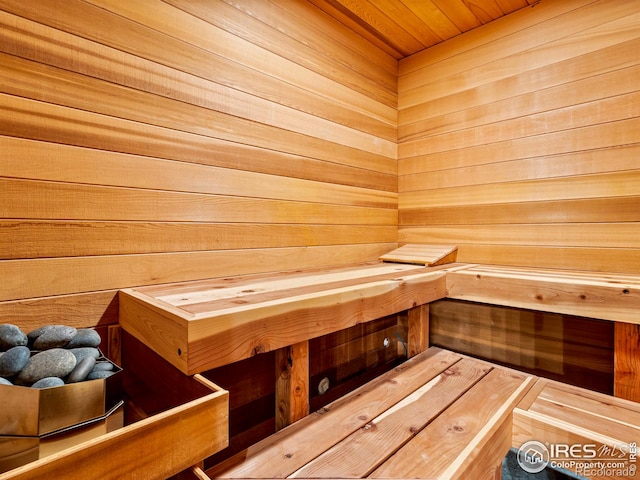 view of sauna / steam room featuring wood walls and wooden ceiling