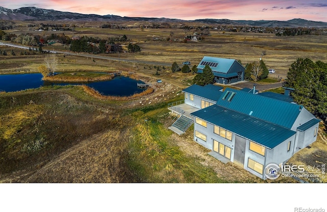 aerial view at dusk featuring a mountain view